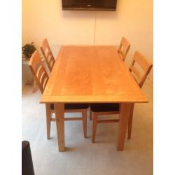 Solid light wood table with four chairs