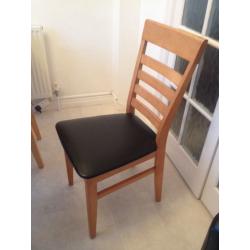 Solid light wood table with four chairs