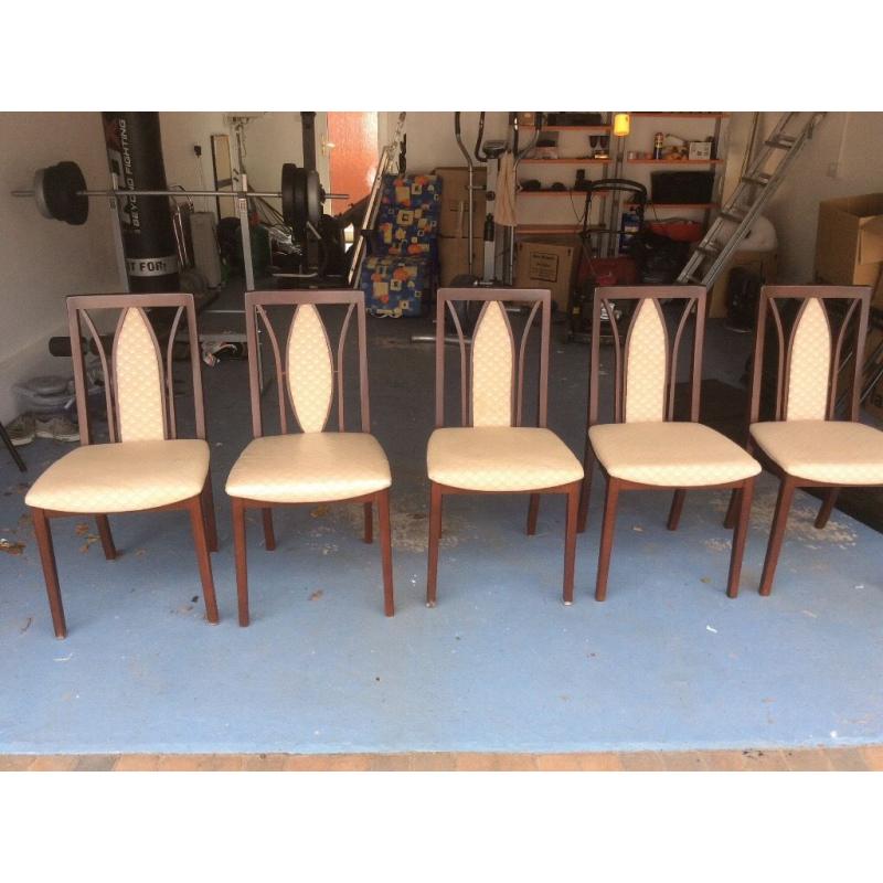 Five wooden, padded dining chairs
