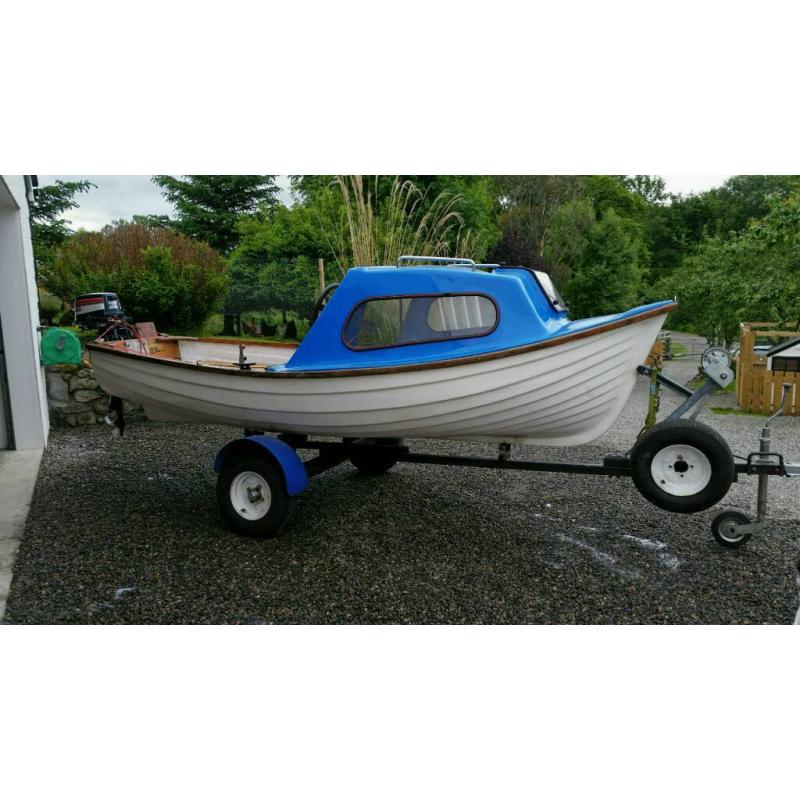 Fishing boat cuddy outboard and trailer.