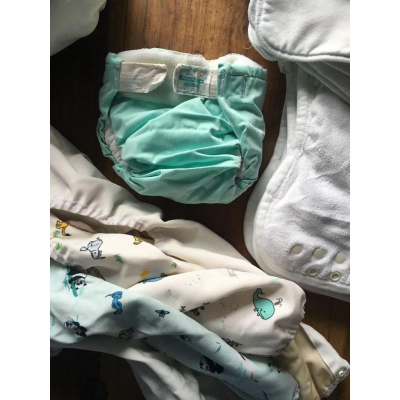 10 cloth nappies, 5 liners and assorted sizes of covers