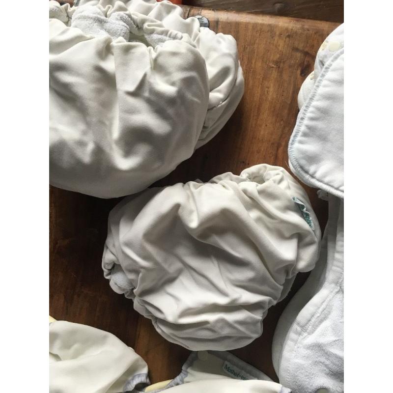 10 cloth nappies, 5 liners and assorted sizes of covers