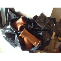 6 lengths of brown drainage pipe with 4 bags of all different connectors
