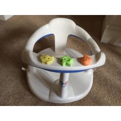 Baby bath seat suctions onto bath