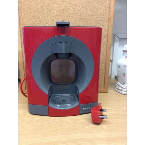 Nescafé Dolce Gusto Coffee Machine in red with 2 boxes of assorted pods
