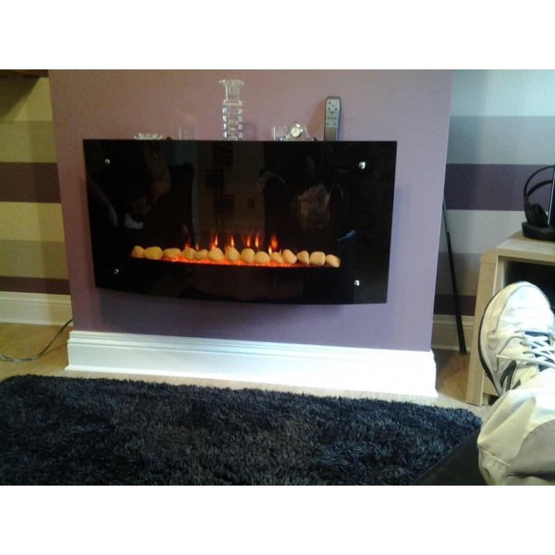 Curved glass electric fire.