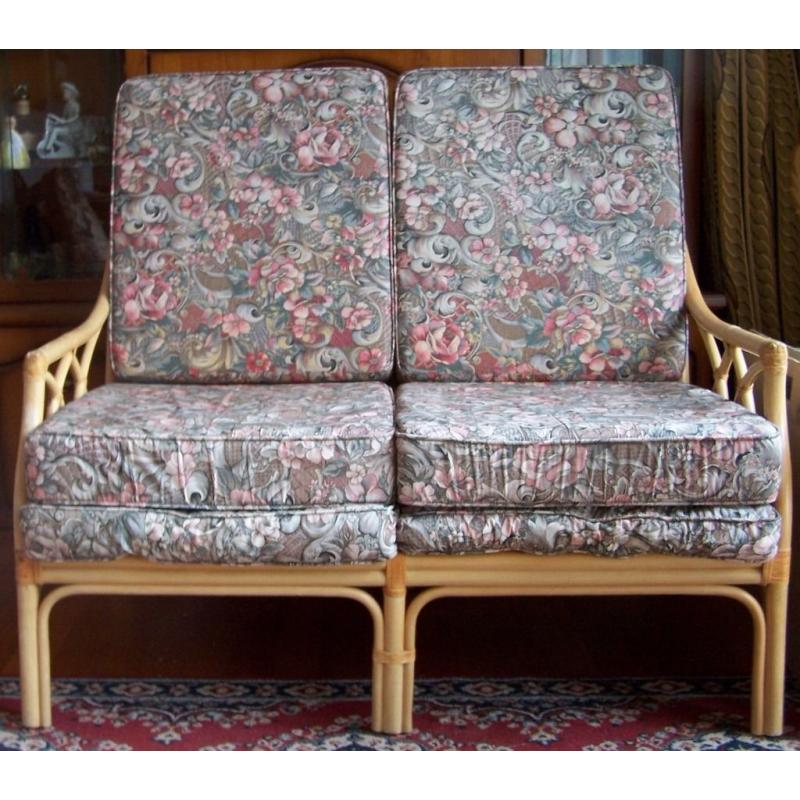 Two seater cane settee with six loose cushions. very comfortable.