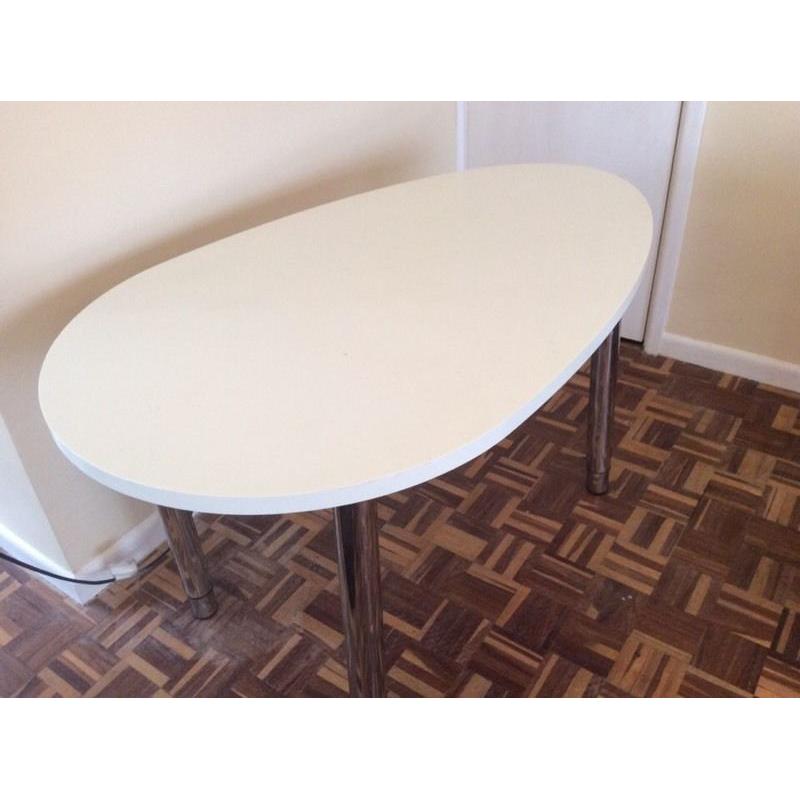 Oval-shaped white desk with chrome adjustable height legs