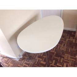 Oval-shaped white desk with chrome adjustable height legs