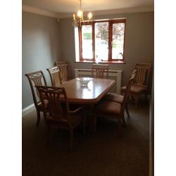 Limed oak dining table, 6 chairs, 2 carvers and large cabinet to match
