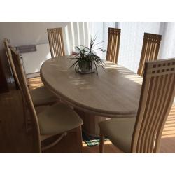 Large marble dinning table and six chairs .