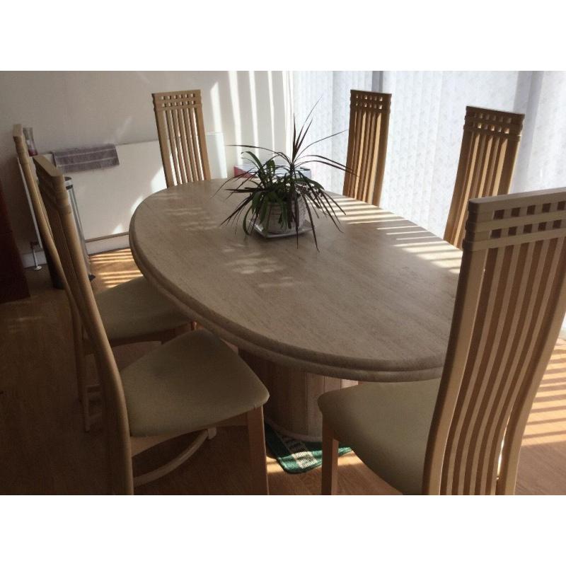 Large marble dinning table and six chairs .