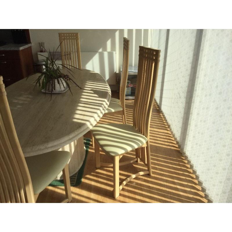 Large marble dinning table and six chairs .