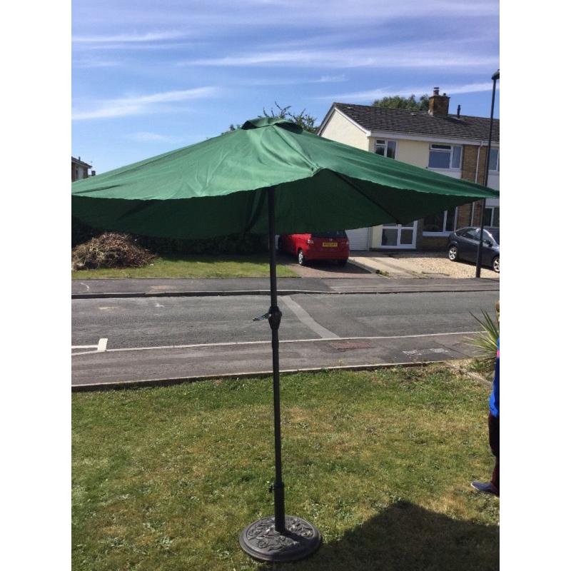 New large green parasol and heavy metal base