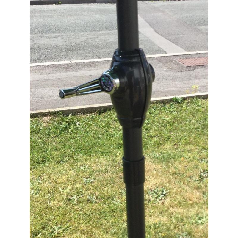 New large green parasol and heavy metal base