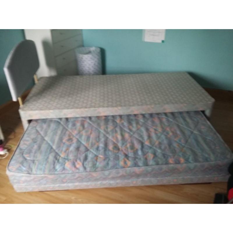 Single bed with headboard and also has trundle pull out bed with trundle mattress