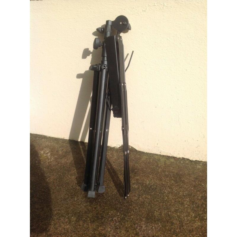 Foldable & adjustable music stand, black metal, for holding sheet music / books in place.