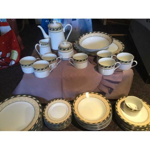 8 person dinner set with 8 piece tea set, tea pot, milk and sugar dishes and two serving dishes.