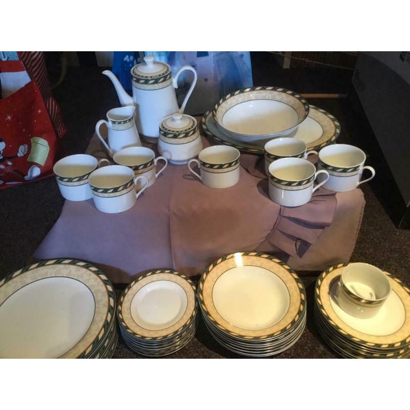 8 person dinner set with 8 piece tea set, tea pot, milk and sugar dishes and two serving dishes.