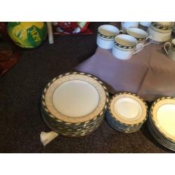 8 person dinner set with 8 piece tea set, tea pot, milk and sugar dishes and two serving dishes.