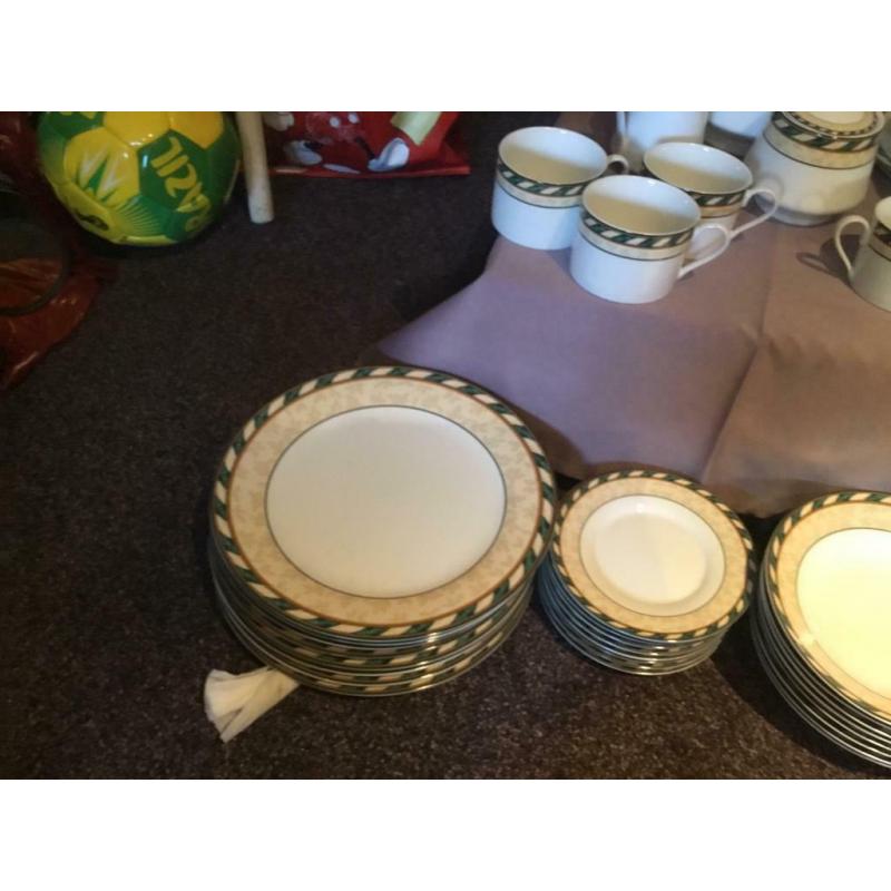 8 person dinner set with 8 piece tea set, tea pot, milk and sugar dishes and two serving dishes.