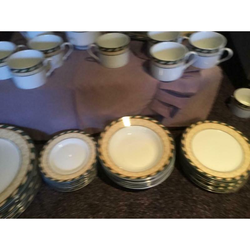 8 person dinner set with 8 piece tea set, tea pot, milk and sugar dishes and two serving dishes.
