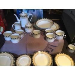 8 person dinner set with 8 piece tea set, tea pot, milk and sugar dishes and two serving dishes.